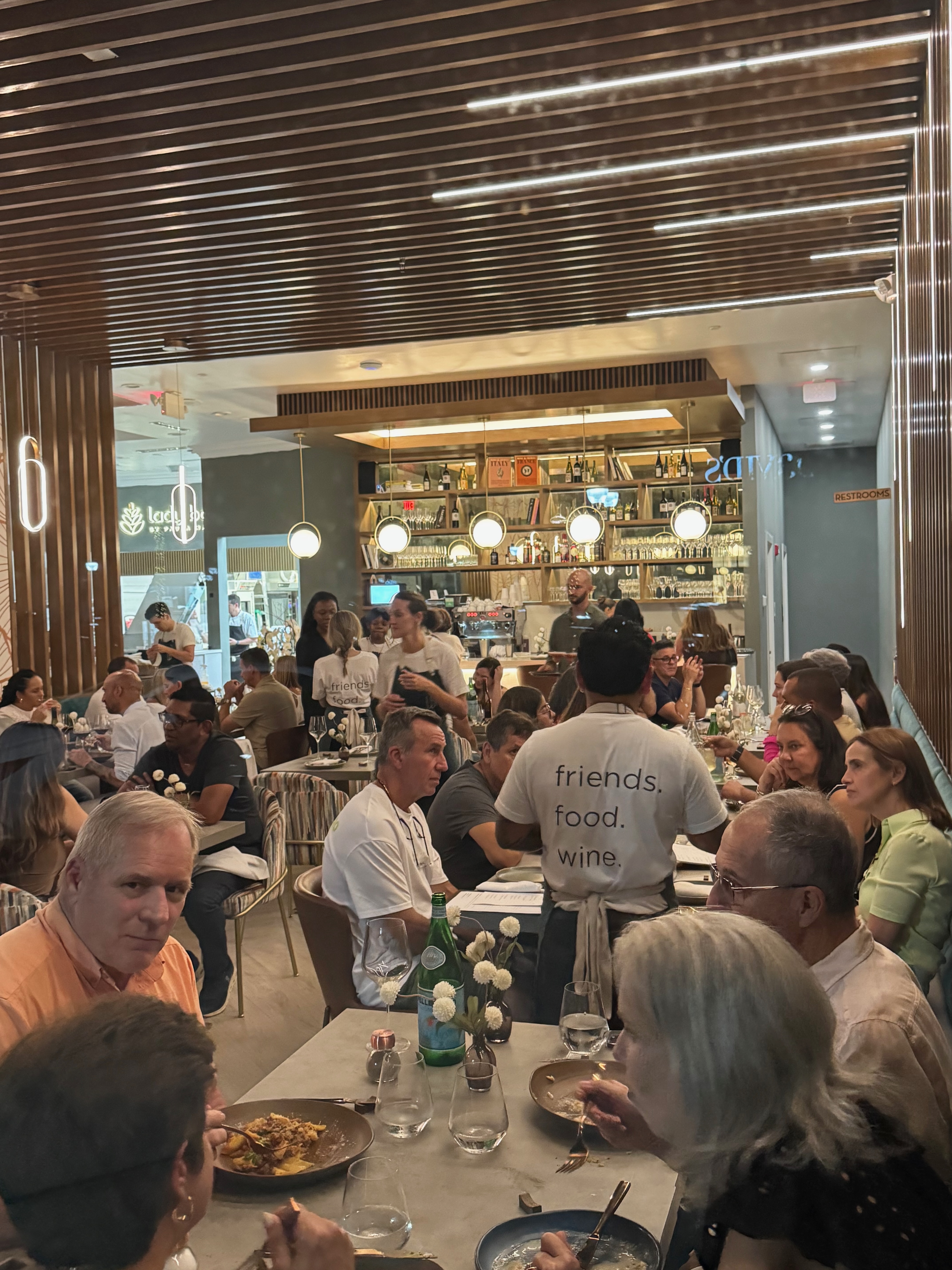 Guests and the hospitality team sharing a lively service at LB Eatery & Wine
