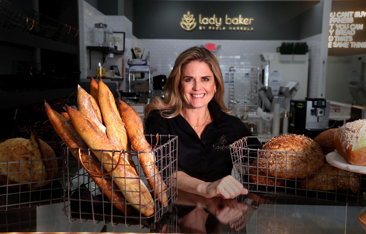 Paula Marsola surrounded by freshly baked bread at Lady Baker